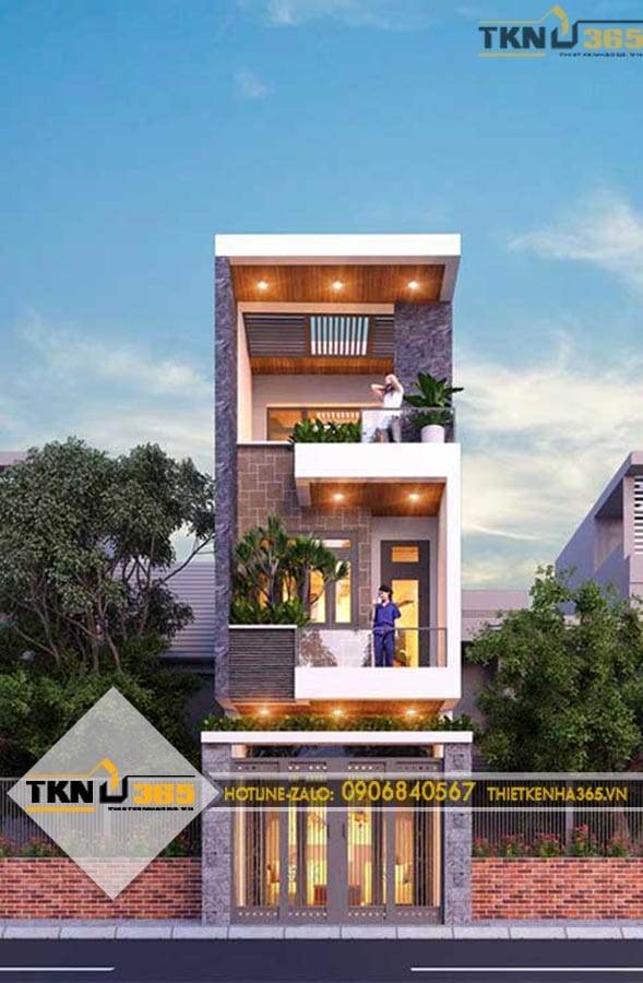 Nhà phố 3 tầng sử dụng các mảng khối hiện đại kết hợp đá ốp, kính và ban công xanh để tăng chiều sâu cho mặt tiền