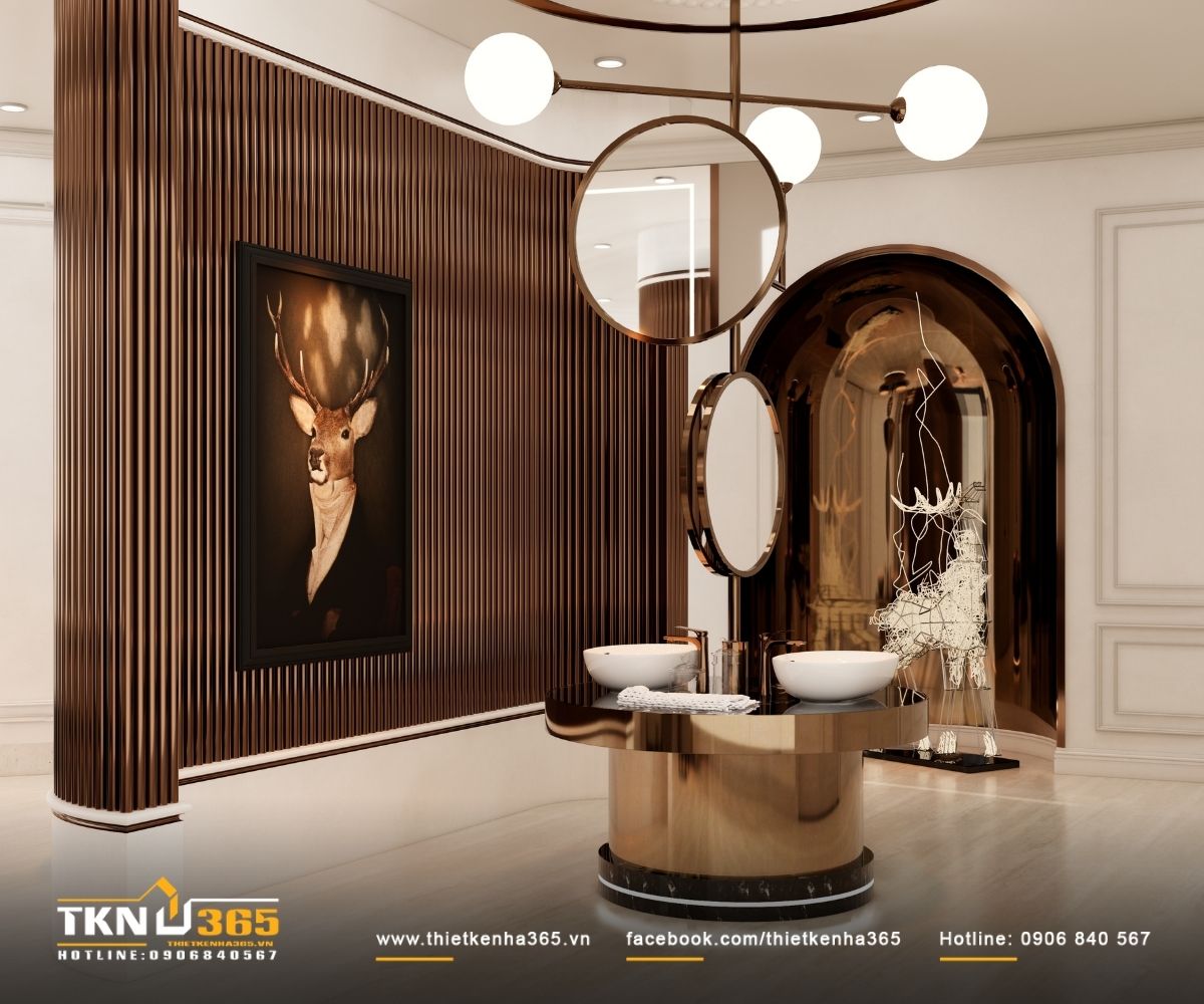 Khu vực lavabo đôi với mảng lam đứng bo cong và gương tròn, ánh sáng gián tiếp giúp bề mặt kim loại ánh đồng trở nên mềm mại