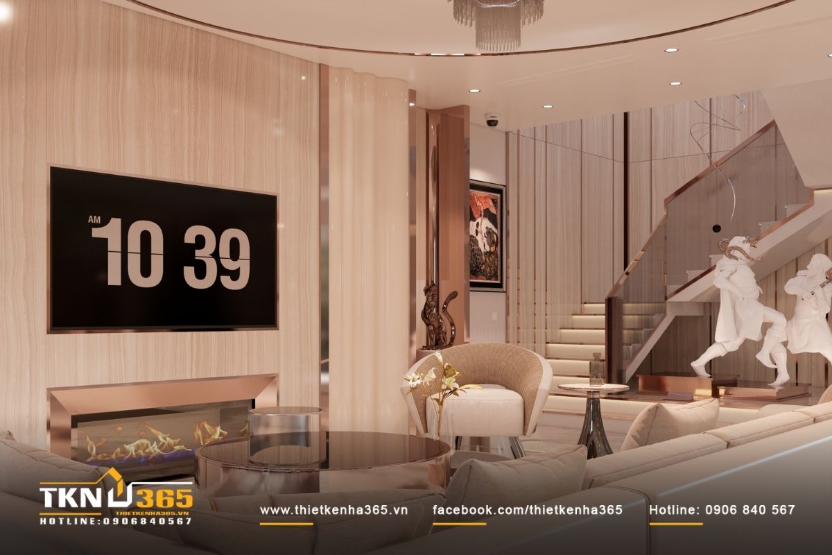 Sofa cong và bàn trà tròn giữ vai trò trung tâm thị giác, làm mềm các mảng phẳng và cân bằng tỷ lệ lớn của không gian biệt thự