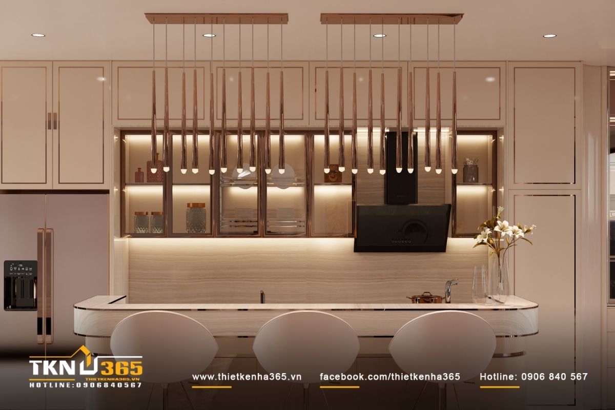 Đảo bếp bo cong kết hợp hệ đèn thả mảnh, tạo điểm nhấn nhẹ nhàng và nhịp điệu thị giác cho không gian bếp mở