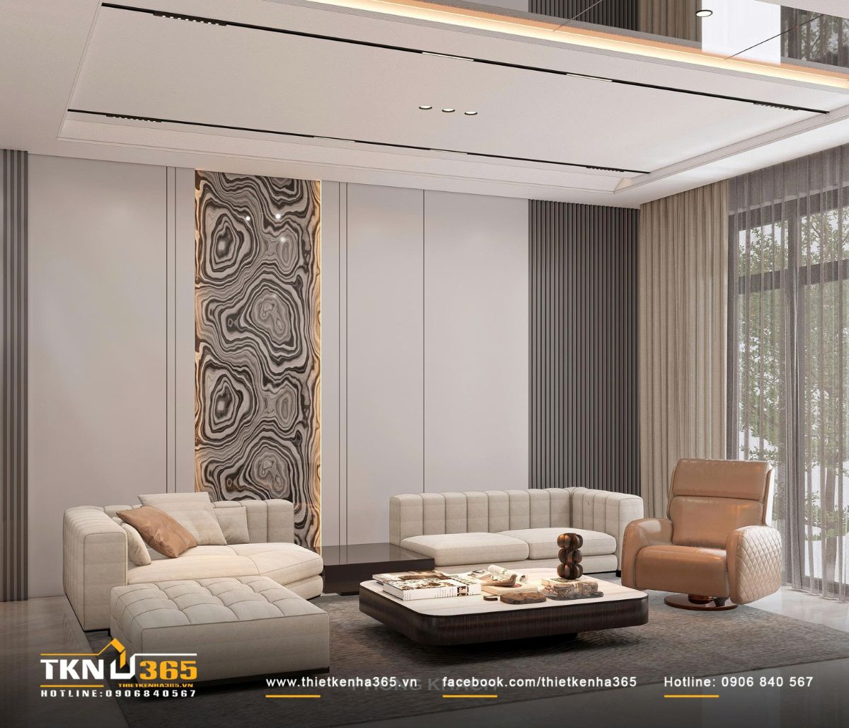 Bố cục sofa sáng màu kết hợp ghế thư giãn da nâu tạo nên sự cân bằng ấm áp trong bảng màu trung tính