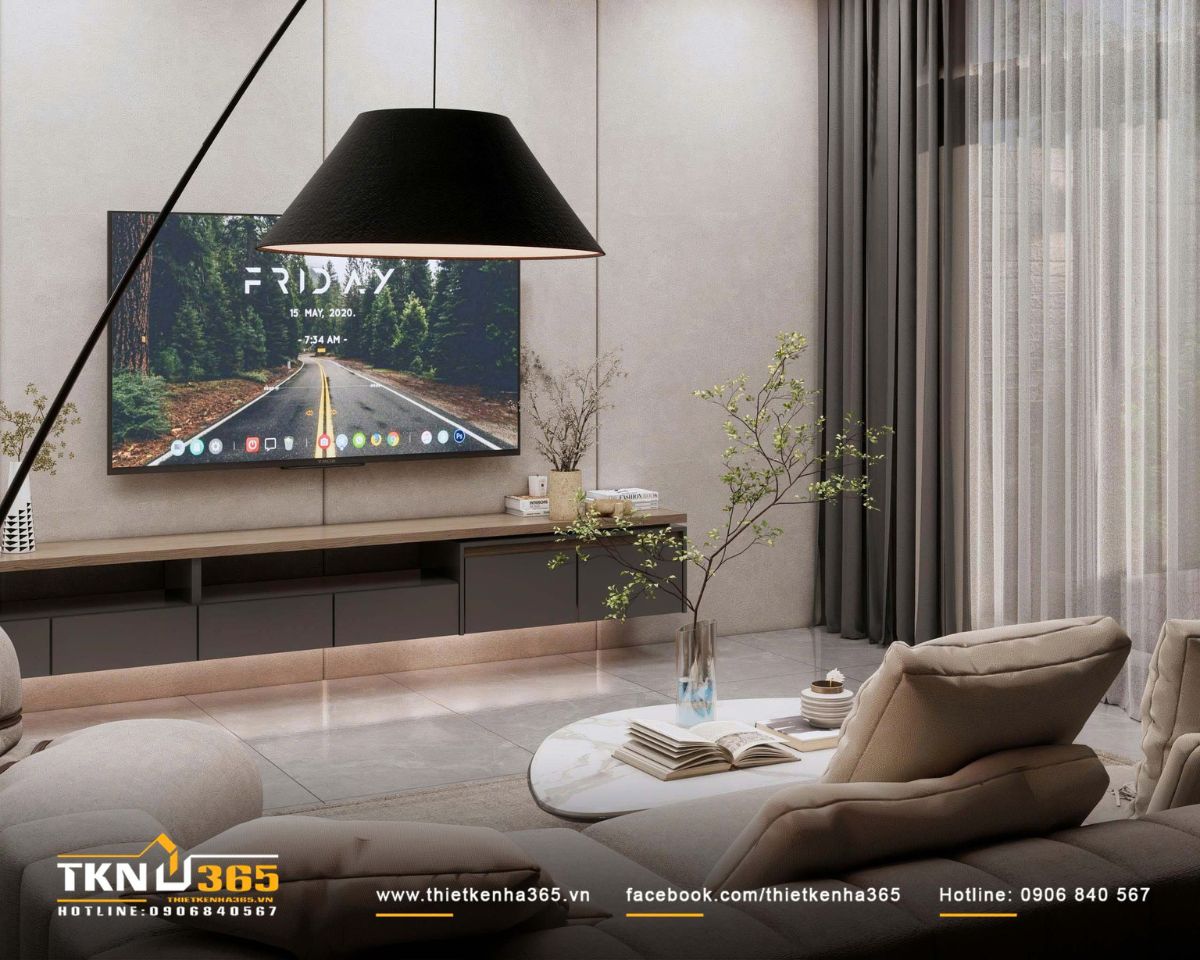 Đèn sàn chụp đen đặt lệch bên ghế lounge tạo điểm nhấn hình khối, đồng thời bổ sung lớp ánh sáng ấm cho không gian sinh hoạt buổi tối