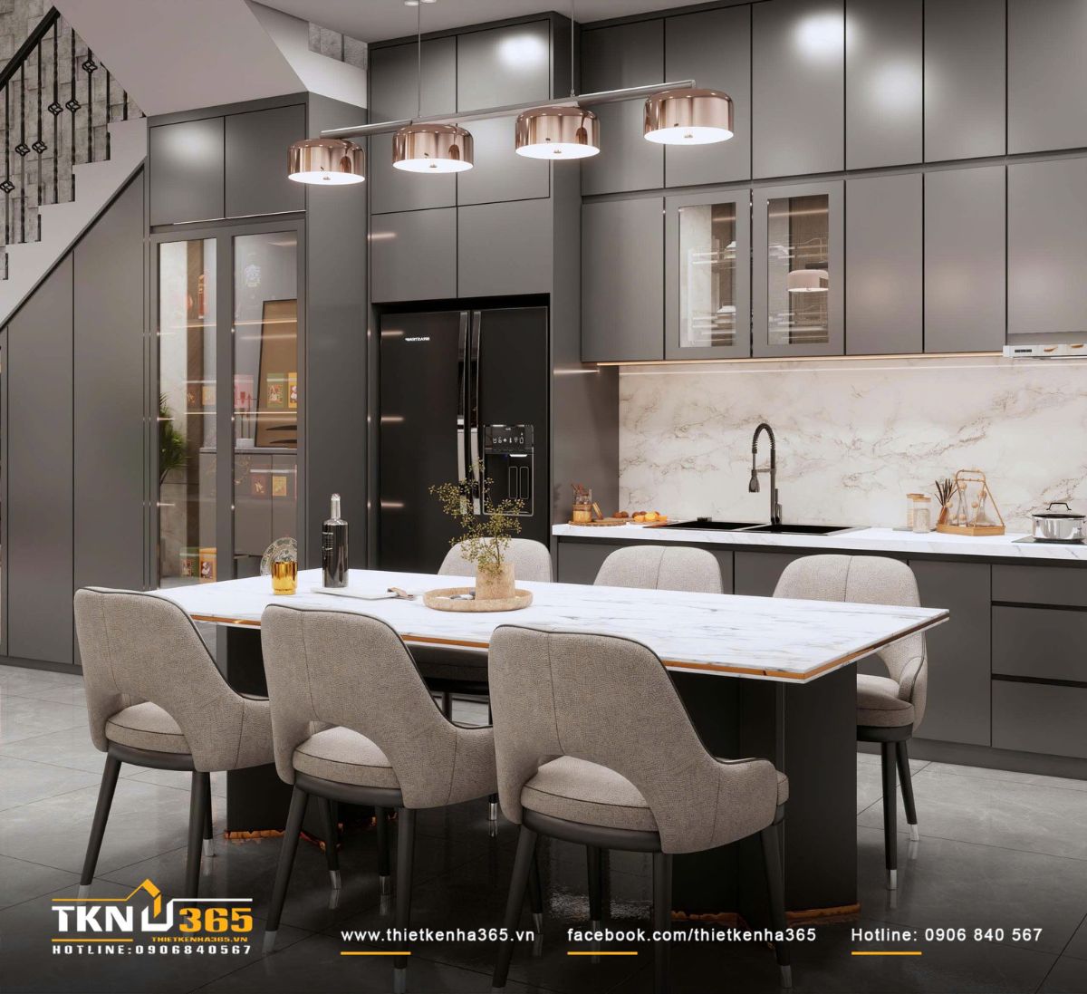 Tổng thể không gian bếp - ăn nổi bật với hệ tủ kịch trần phẳng màu xám đậm kết hợp đá trắng vân mây, tạo nên sự tương phản rõ ràng nhưng vẫn giữ tinh thần trung tính xuyên suốt tầng trệt