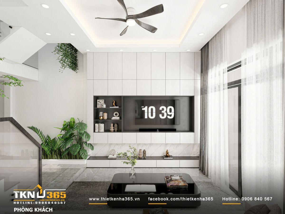 Thiết kế nội thất nhà phố mặt tiền 3m - Giải quyết bài toán ánh sáng và tổ chức không gian hẹp 3 Hệ tủ tivi âm tường kéo dài kết hợp ánh sáng gián tiếp và rèm hai lớp, giúp khu vực sinh hoạt chung sáng dịu và rộng hơn diện tích thực