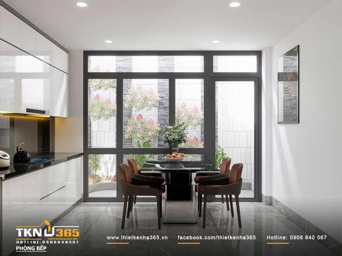Thiết kế nội thất nhà phố mặt tiền 3m - Giải quyết bài toán ánh sáng và tổ chức không gian hẹp 5 Bàn ăn đặt sát hệ cửa kính lớn, tận dụng ánh sáng tự nhiên và khoảng xanh bên ngoài để tăng sự thoáng đãng cho không gian bếp - ăn