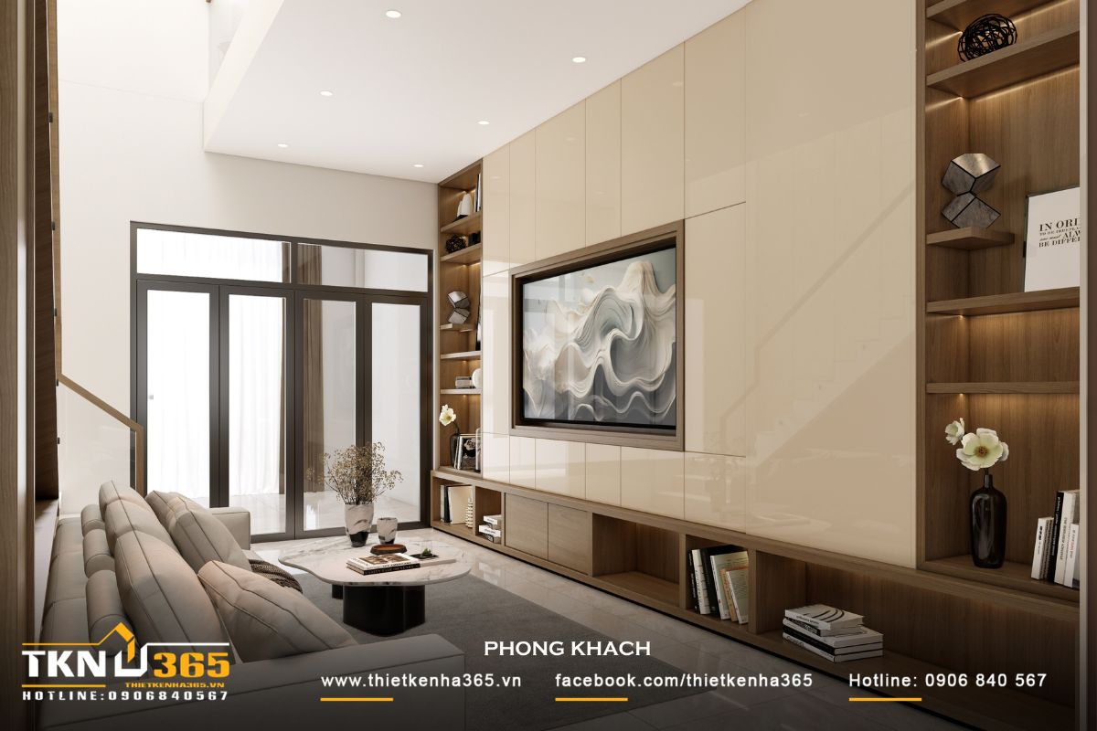 Hệ vách tivi xử lý phẳng và liền mạch, kết hợp cùng kệ thấp và các ô trang trí âm tường, tạo nên tổng thể gọn gàng và có chiều sâu