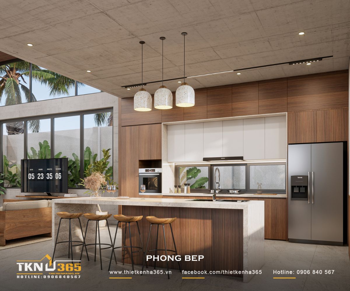 Nhà phố 1 tầng 8x15m biến khoảng sân rộng thành không gian nghỉ dưỡng mỗi ngày 31 Hệ cửa sổ chạy dọc bàn bếp bổ sung ánh sáng cho khu vực thao tác, trong khi đảo bếp hướng ra sân vườn tạo tầm nhìn thoáng khi sử dụng