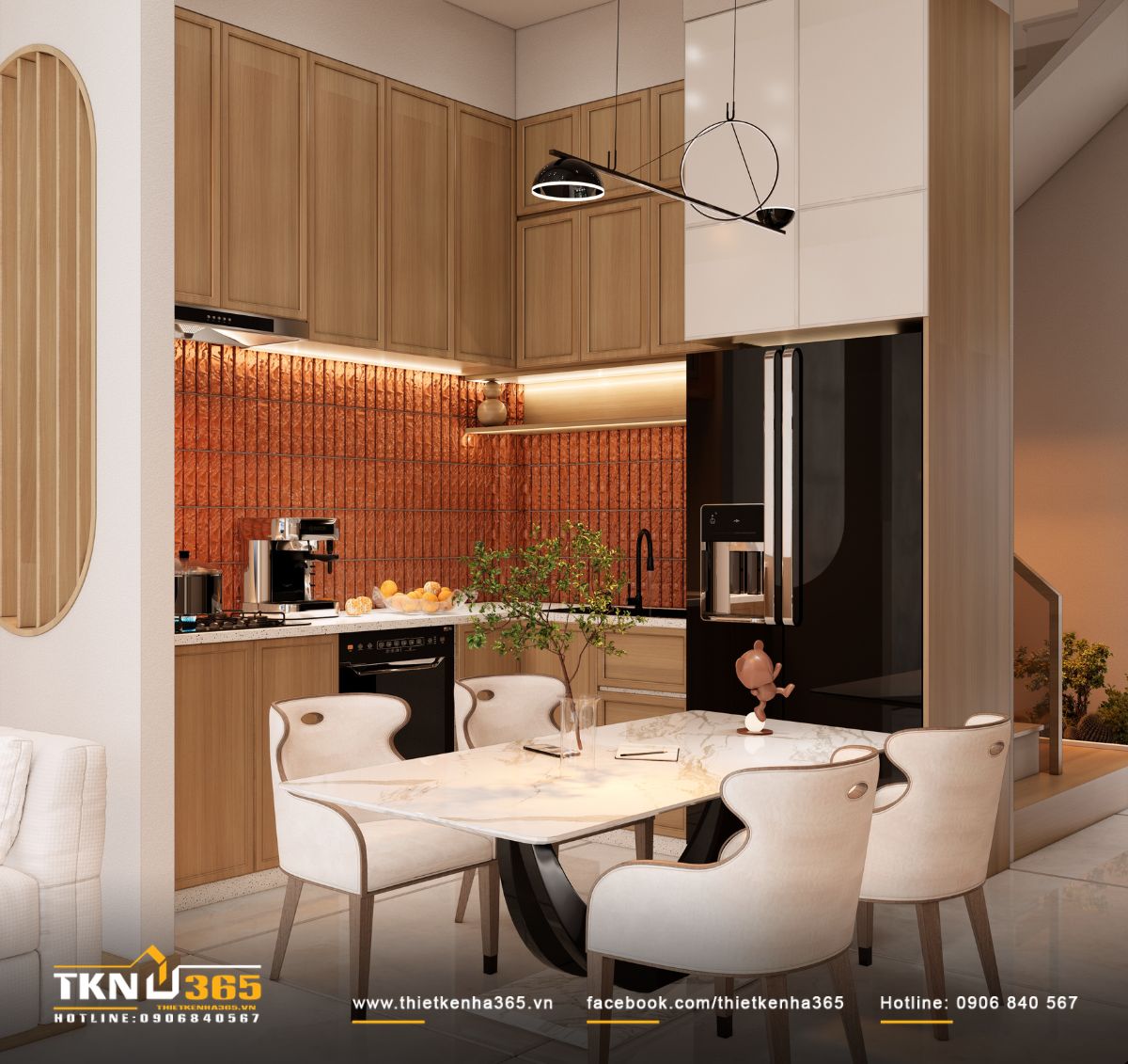 Bếp tận dụng hai cạnh tường để tăng diện tích lưu trữ, đồng thời đưa tủ lạnh và thiết bị lớn vào cùng hệ tủ để không gian gọn gàng hơn